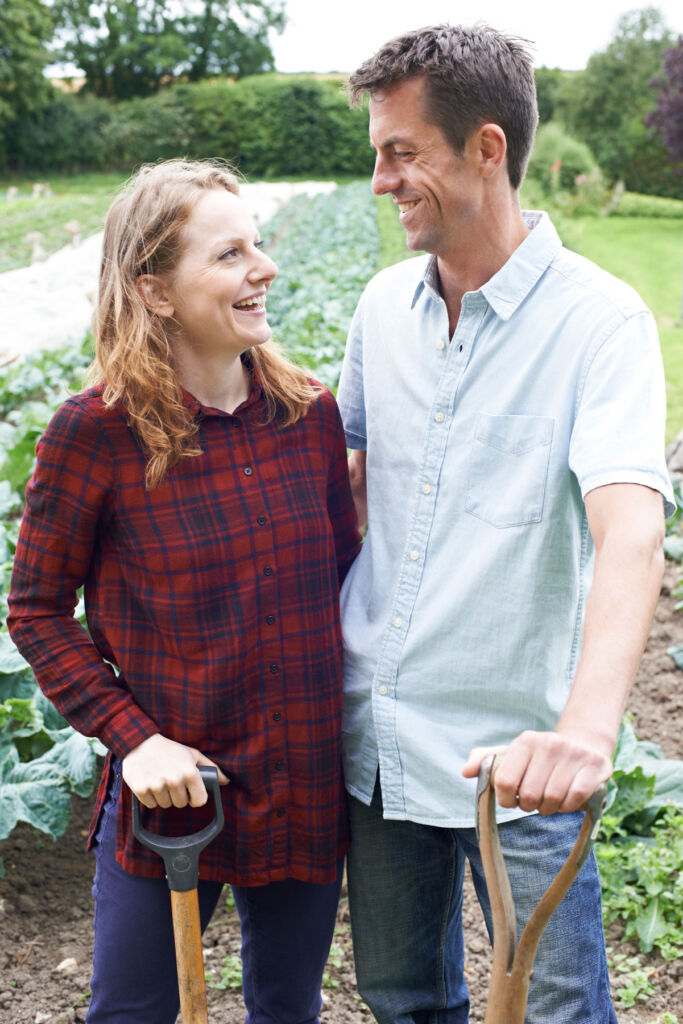 A couple enjoying planting crops in a field