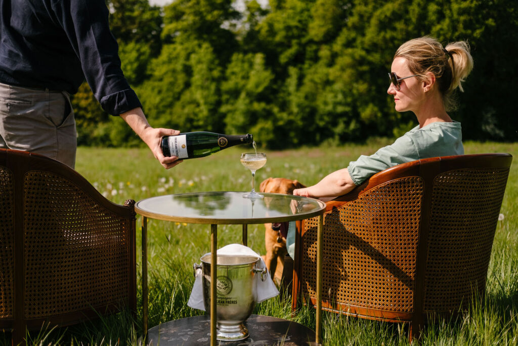 A woman relaxing in the ground enjoying a glass of champagne