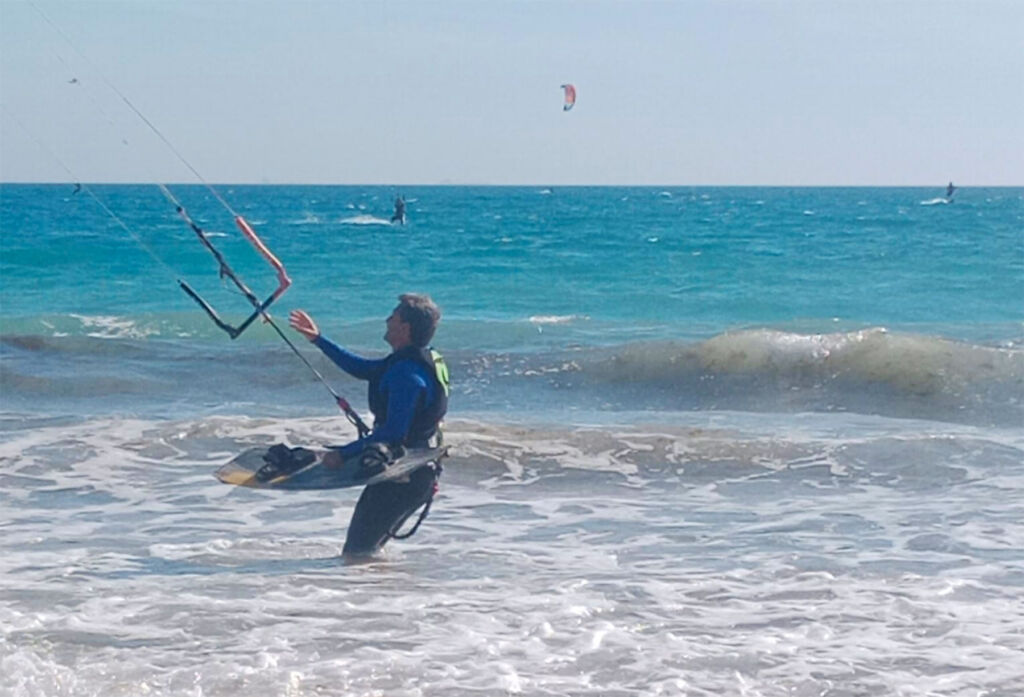 A man in the water ready to embark on a kitesurf