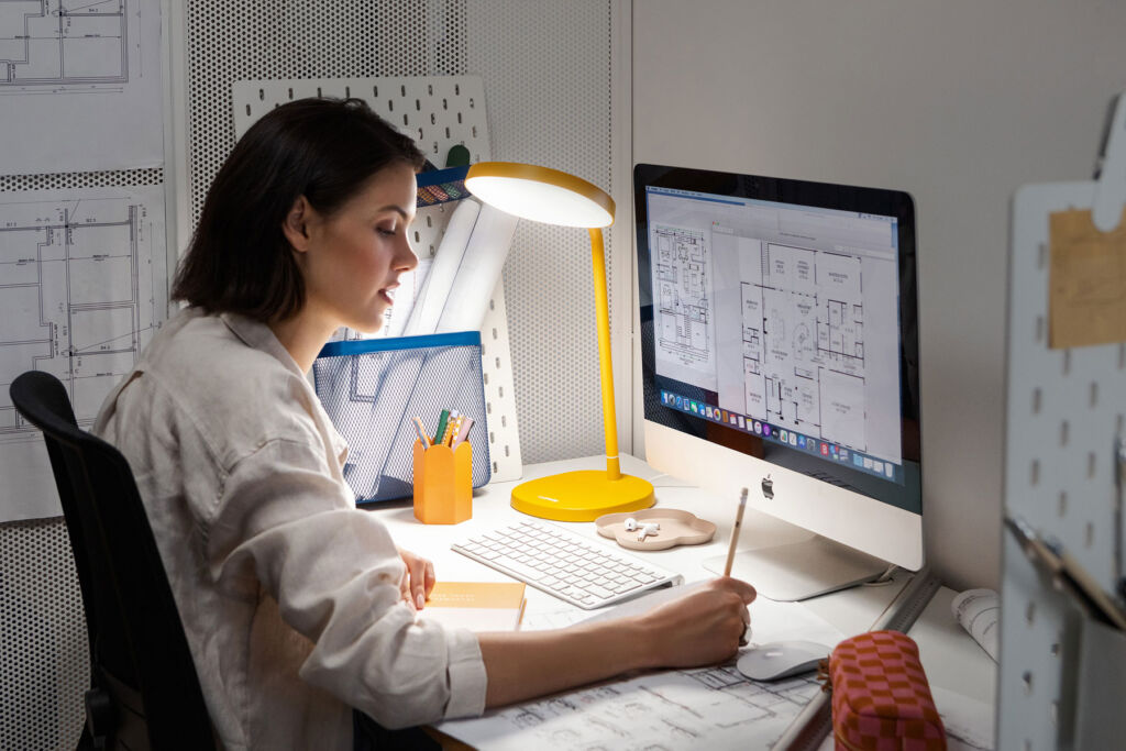 A woman studying a detailed floor plan on her screen