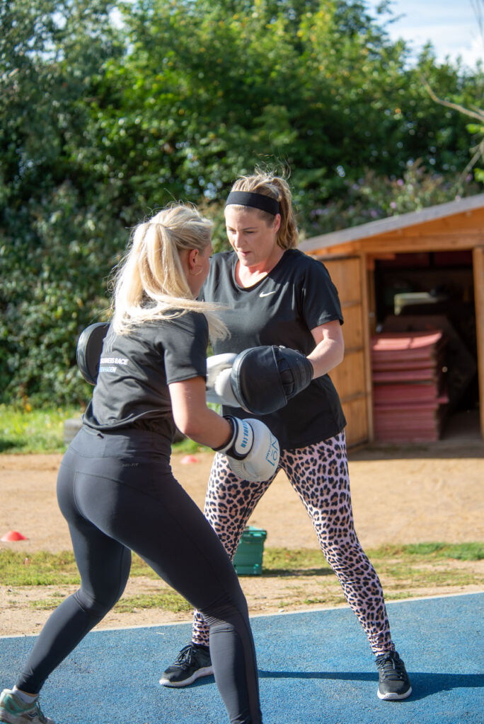 Two ladies practicing punching techniques