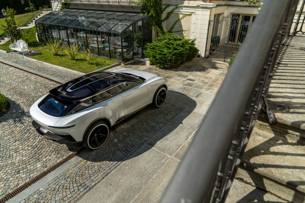 An aerial view of the luxury concept car outside a property