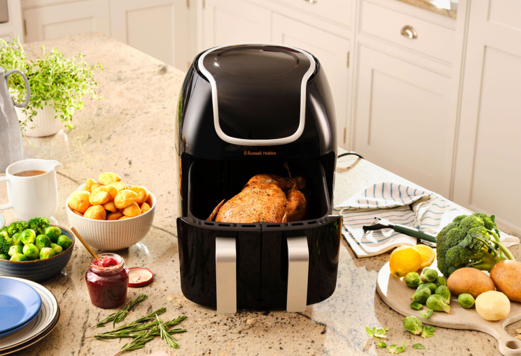 The air fryer in single basket mode cooking a whole chicken