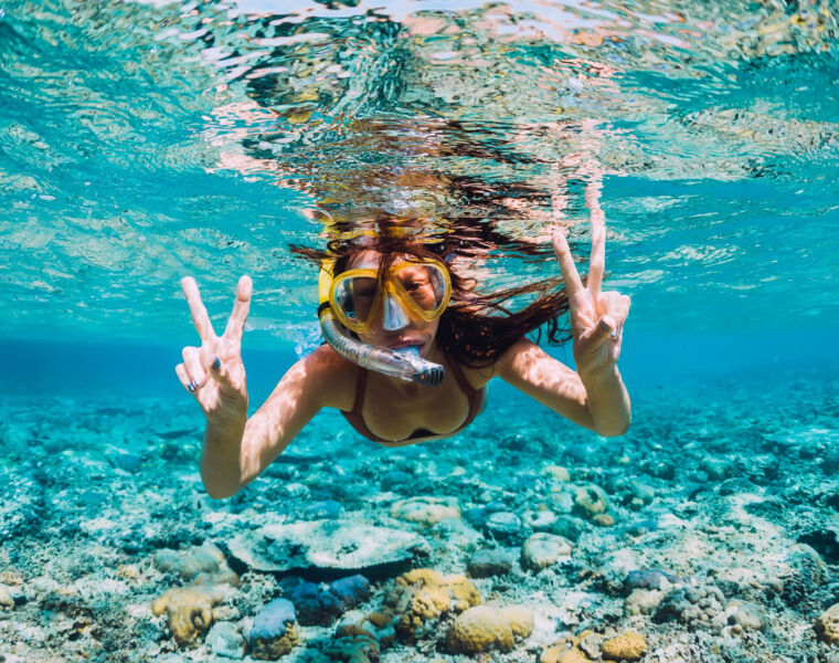 A young woman snorkelling at the resort