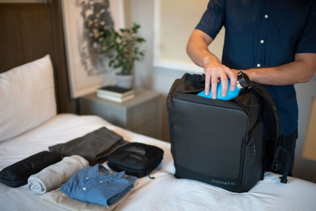 A man packing for some time away using one of the more rigid bags in the range