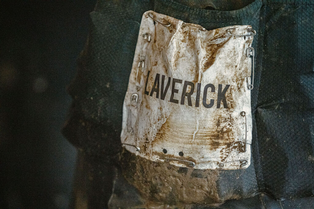 A photograph of Joe's mud splattered name tag on his clothing