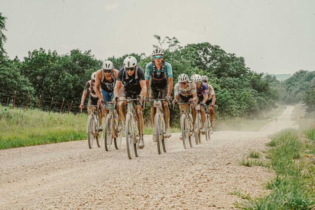 A small group of cyclists racing on a slight incline