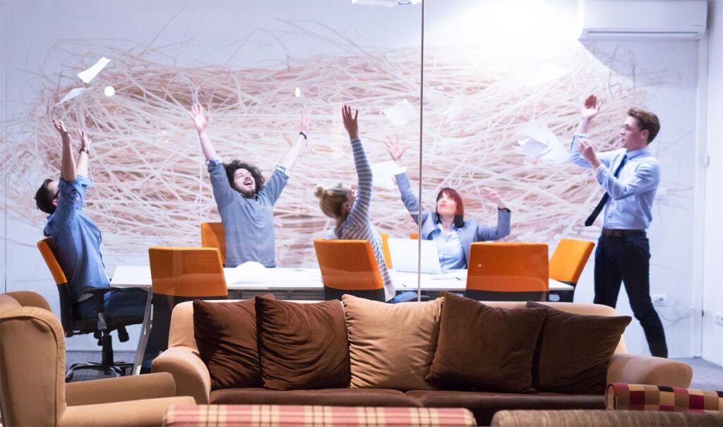 A group of people celebrating in an office