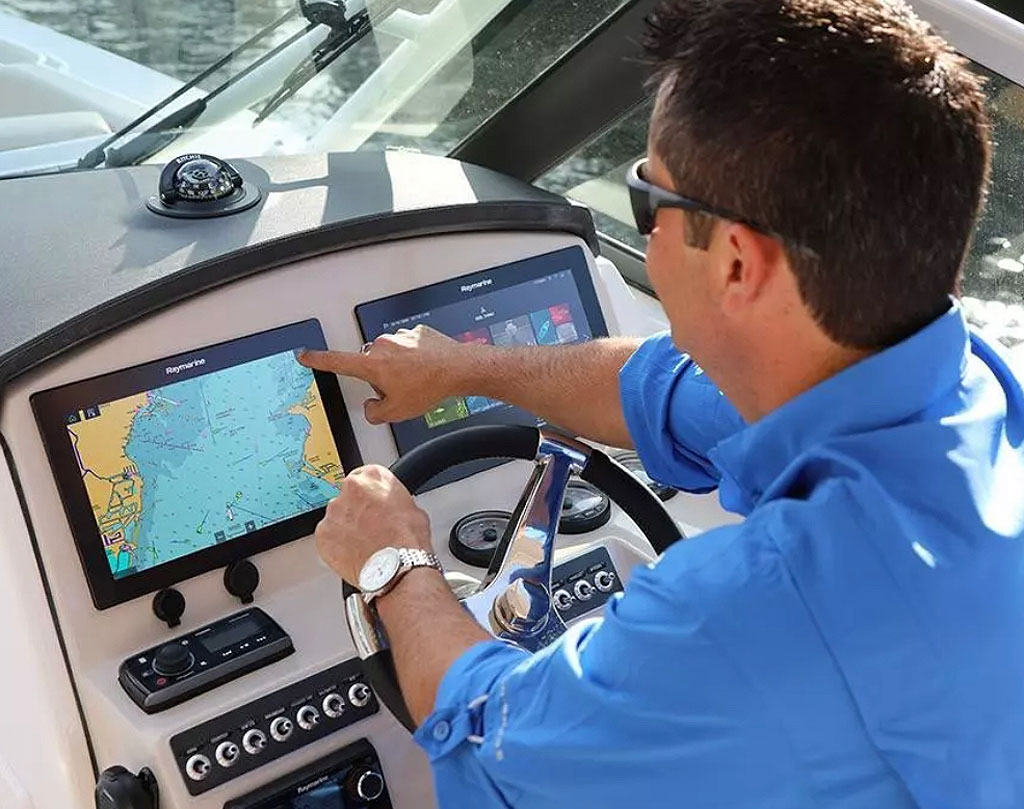 A man using the Chartplotter on his sailing yacht