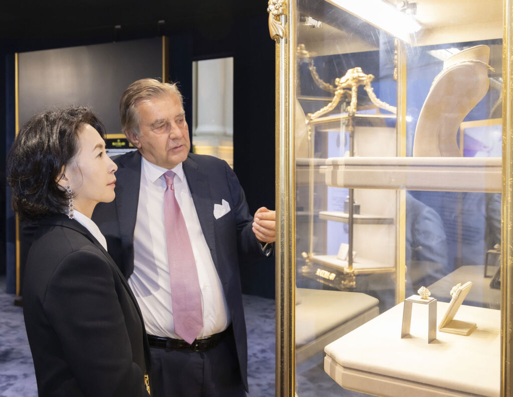 Dignitaries looking at some of the brand's pieces in a cabinet