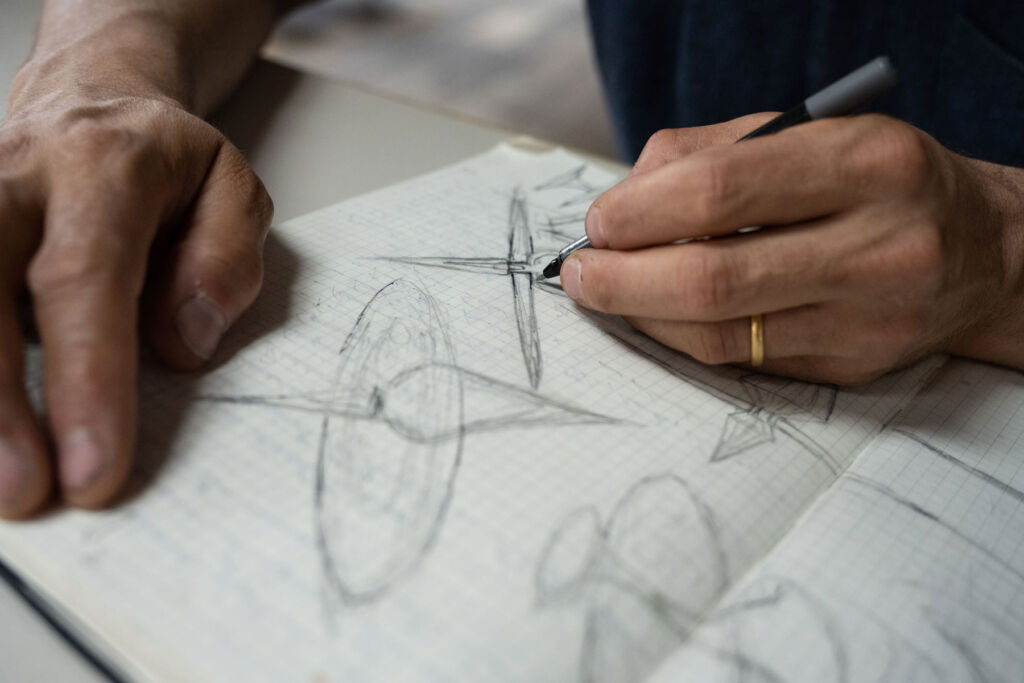 Conrad sketching out the design on paper