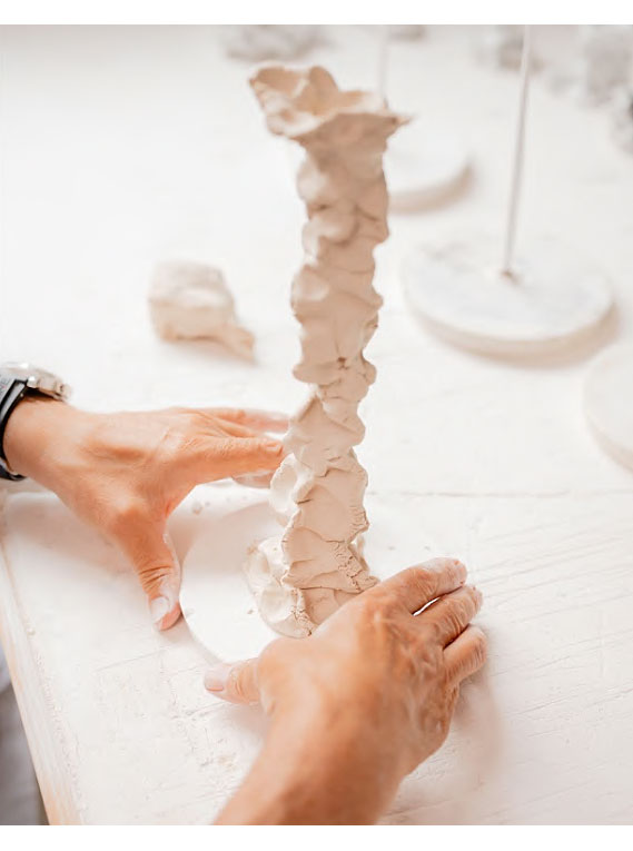 The artist moulding the porcelain with his hands