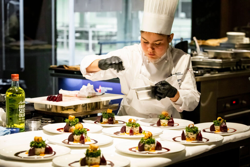 A young chef preparing dishes in one of the regional finals
