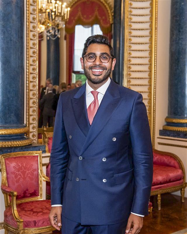 A smiling Shameet in a stately home