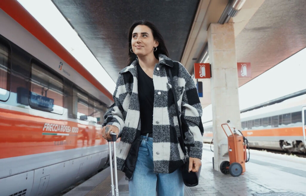 A young woman heading to board a train