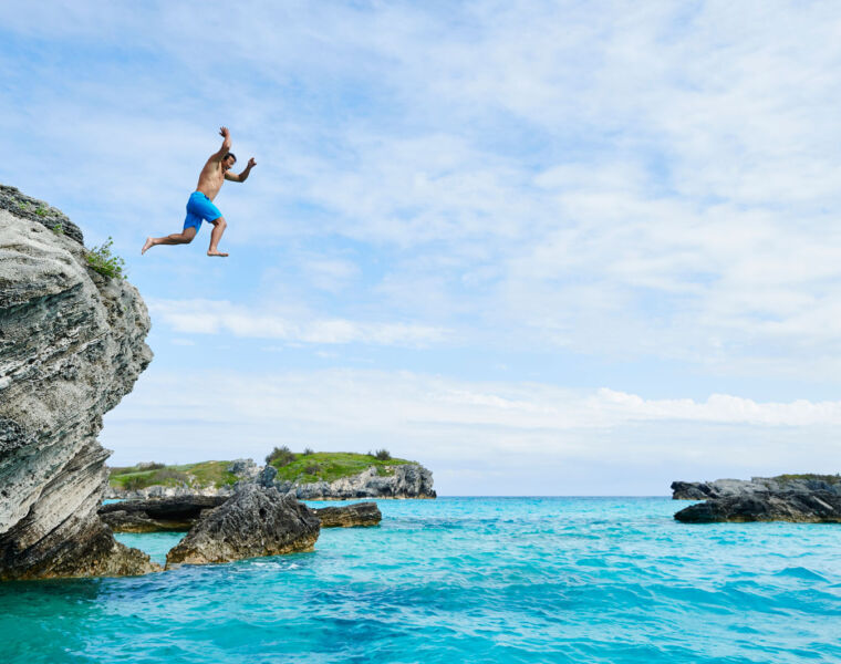 A man jumping off a cliff
