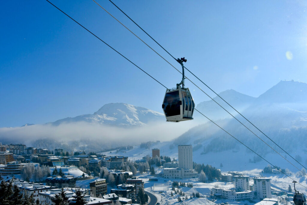 A cable car transporting people up and down the mountains