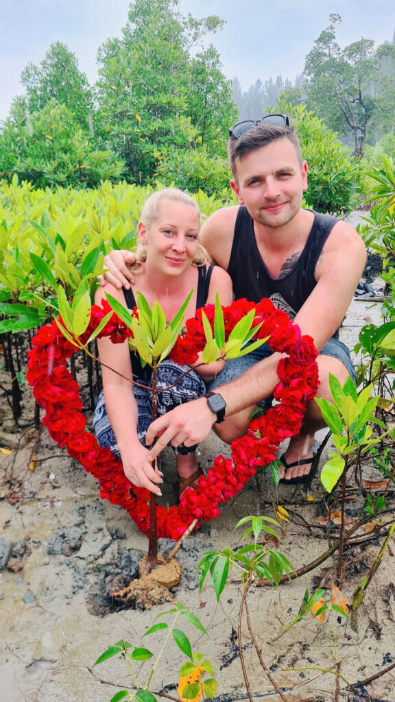 Two guests holding a floral heart
