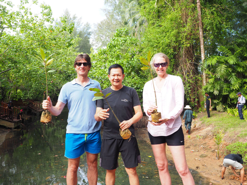 Guests celebrating after planting some trees