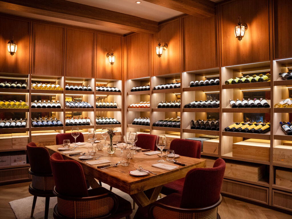 The private dining table surrounded by walls filled with fine French wines