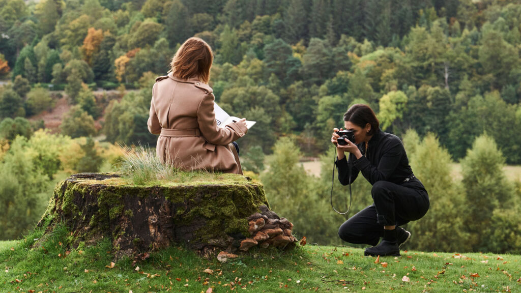 The sisters taking photographs in the Scottish hills