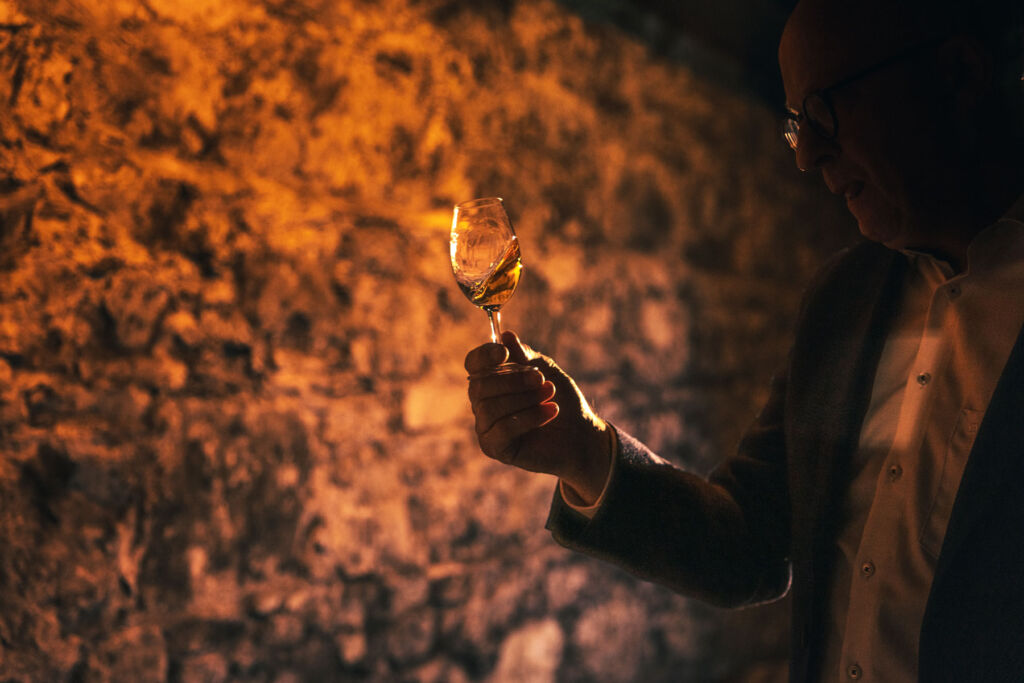 Kevin in the cellar admiring a glass of the whiskey