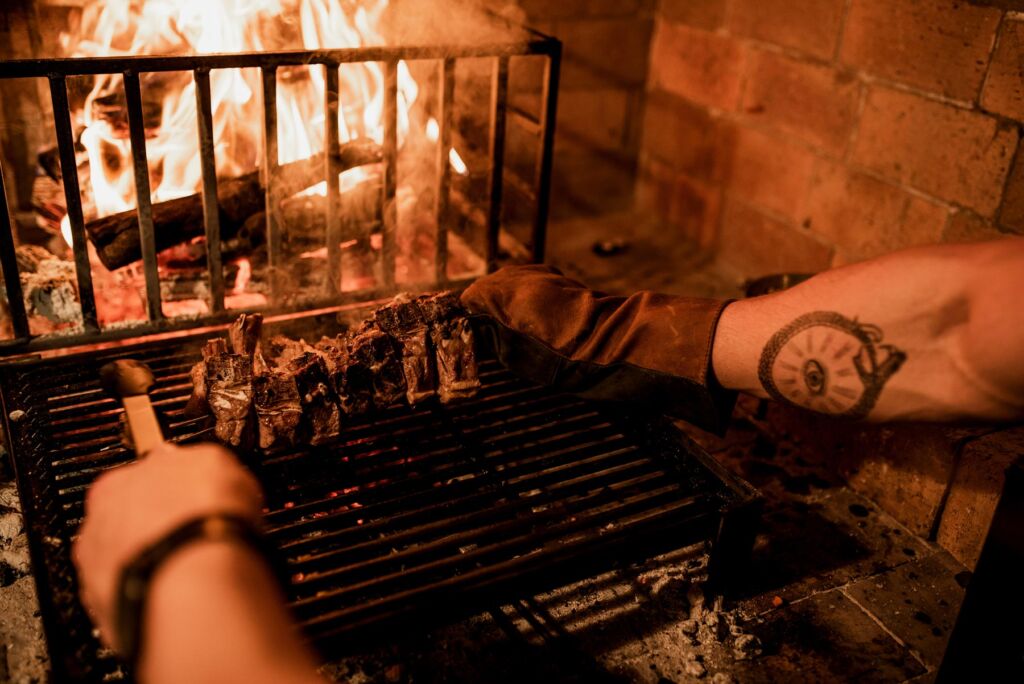Meat being cooked over a fire in the restaurant