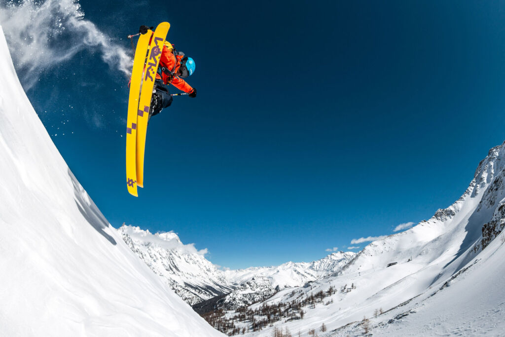 A skier getting some air coming down a slope