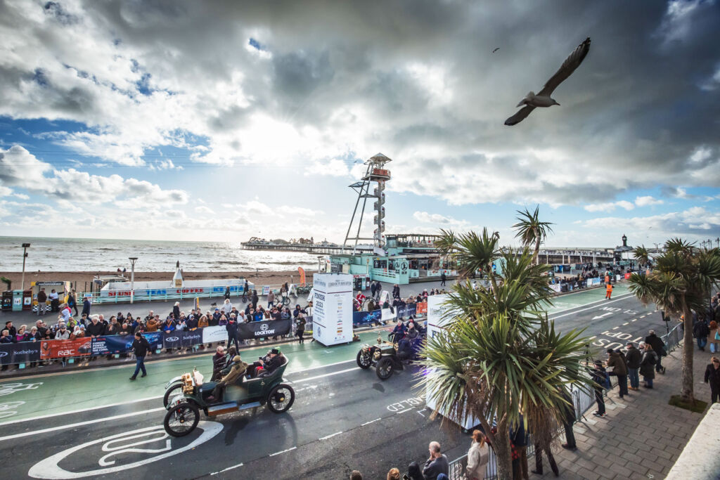 Some of the cars crossing the finishing line in front of Brighton Pier