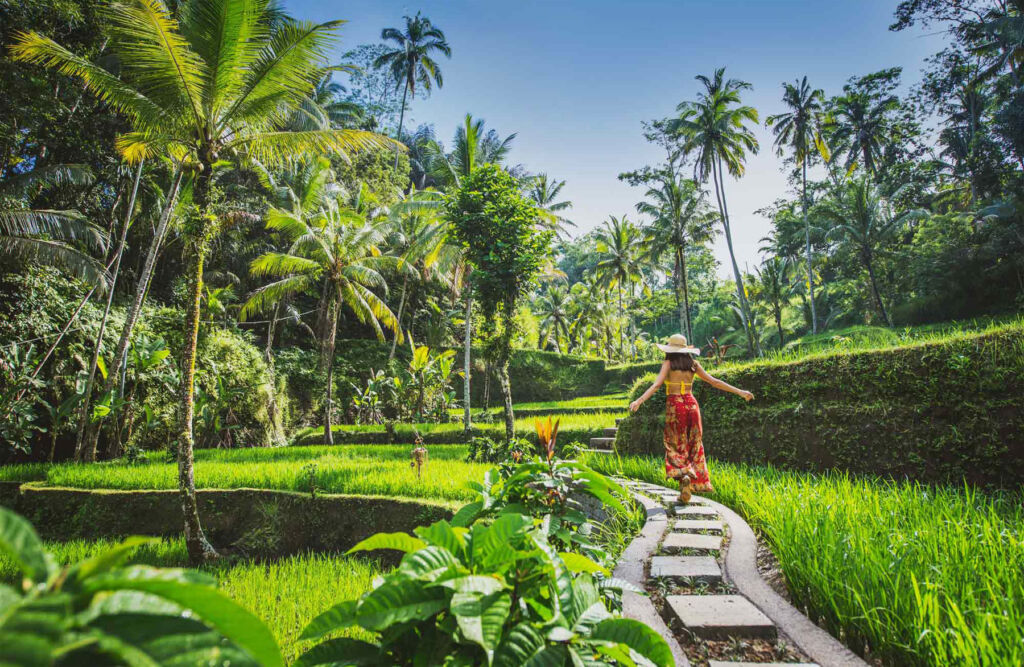 A woman excitedly experiencing the incredible greenery in Bali