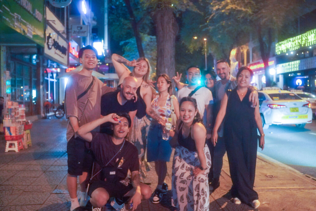 The restaurant's team in joyful mood, posing for a group photo at night in the street