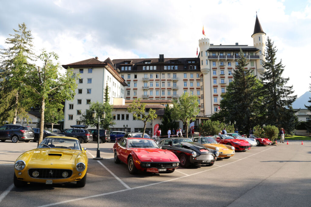 Classic sports cars parked outside the hotel