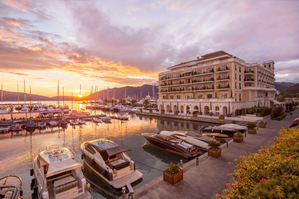 The exterior of the hotel at sunset showing its spectacular location in the marina