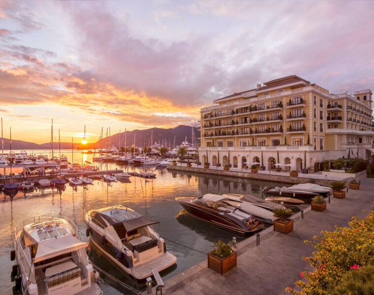 The exterior of the hotel at sunset showing its spectacular location in the marina