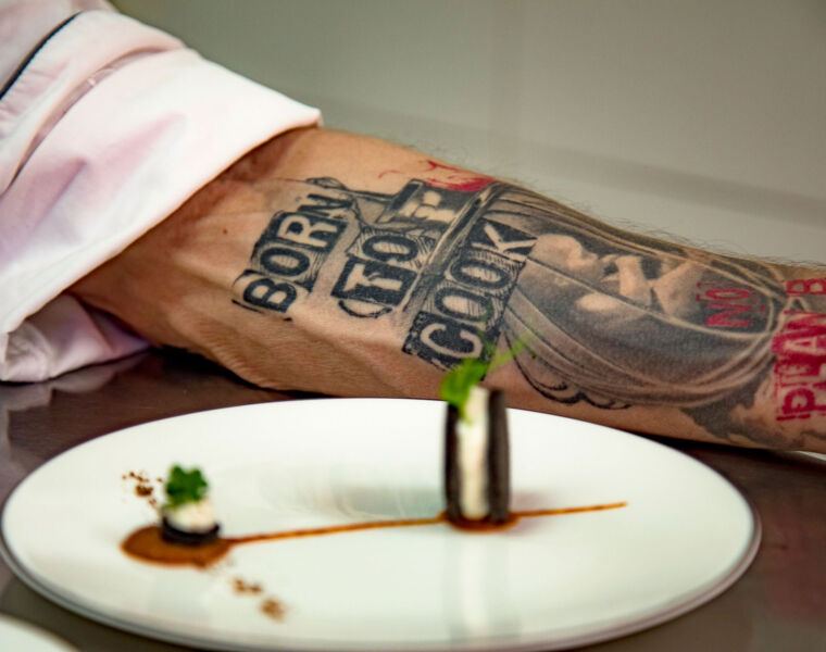 Eyck's tattoo with the words "Born to Cook"