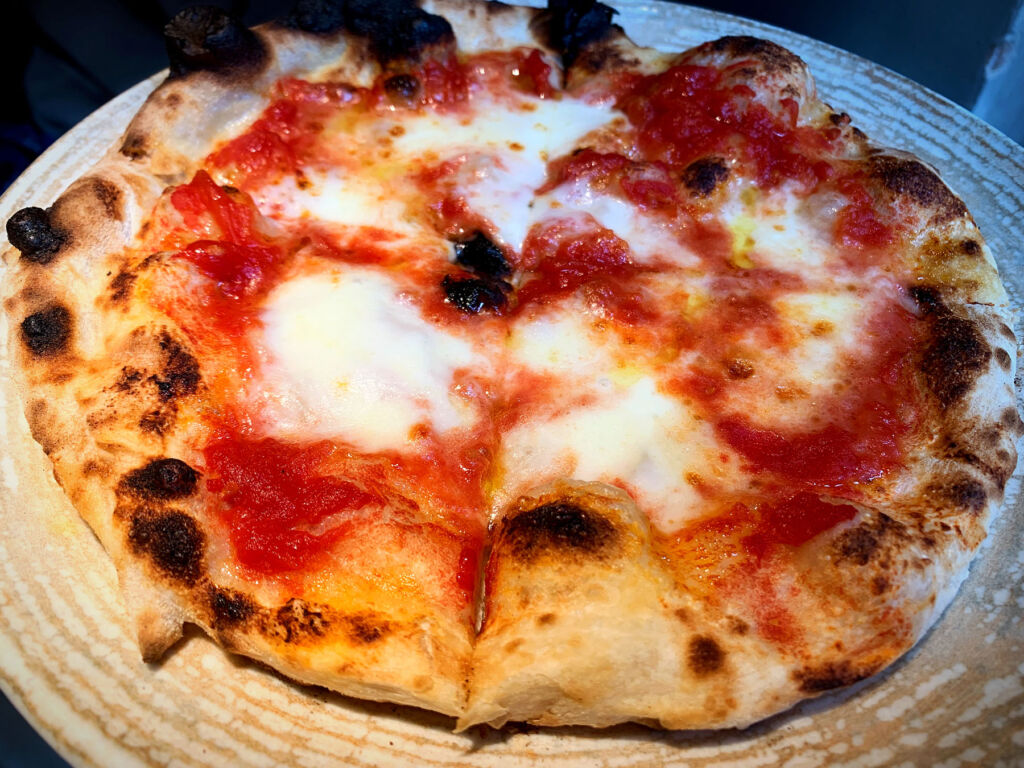 A closeup photograph of the wood fired pizza
