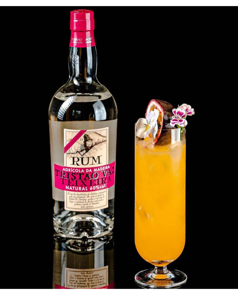 A bottle of 60% natural rum next to a cocktail