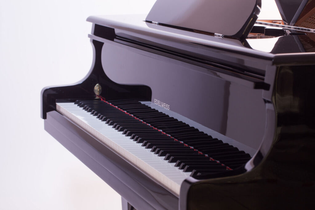 A close up view of the keys on a black coloured grand piano