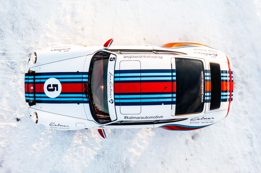 A top down view of a classic 911 in a Martini livery