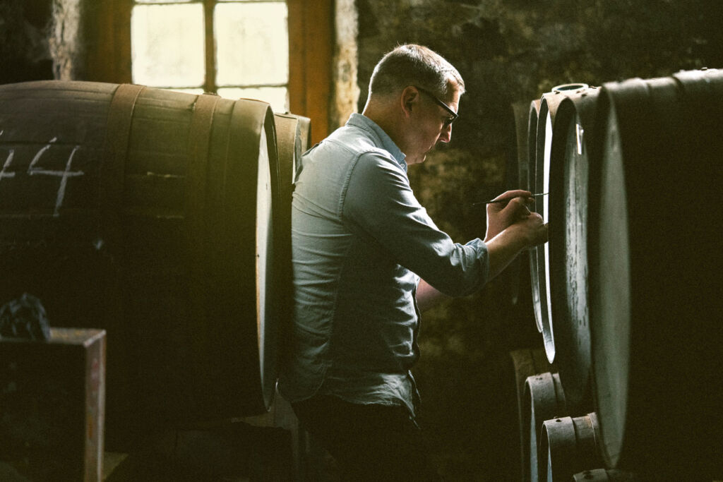 A man selecting the casks in the cellars
