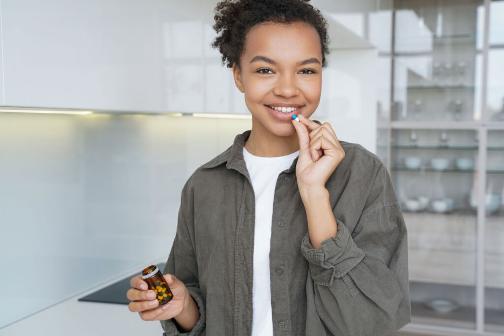 A young woman taking a vitamin supplement