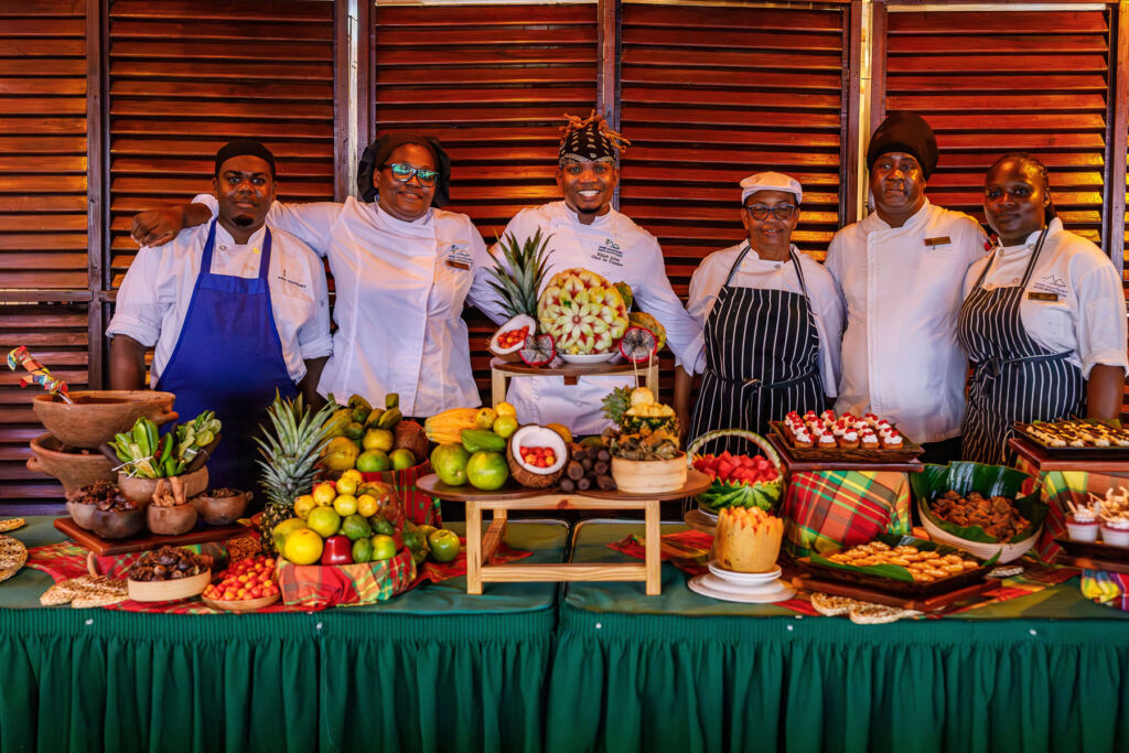 The chef's standing in front of a delicious buffet