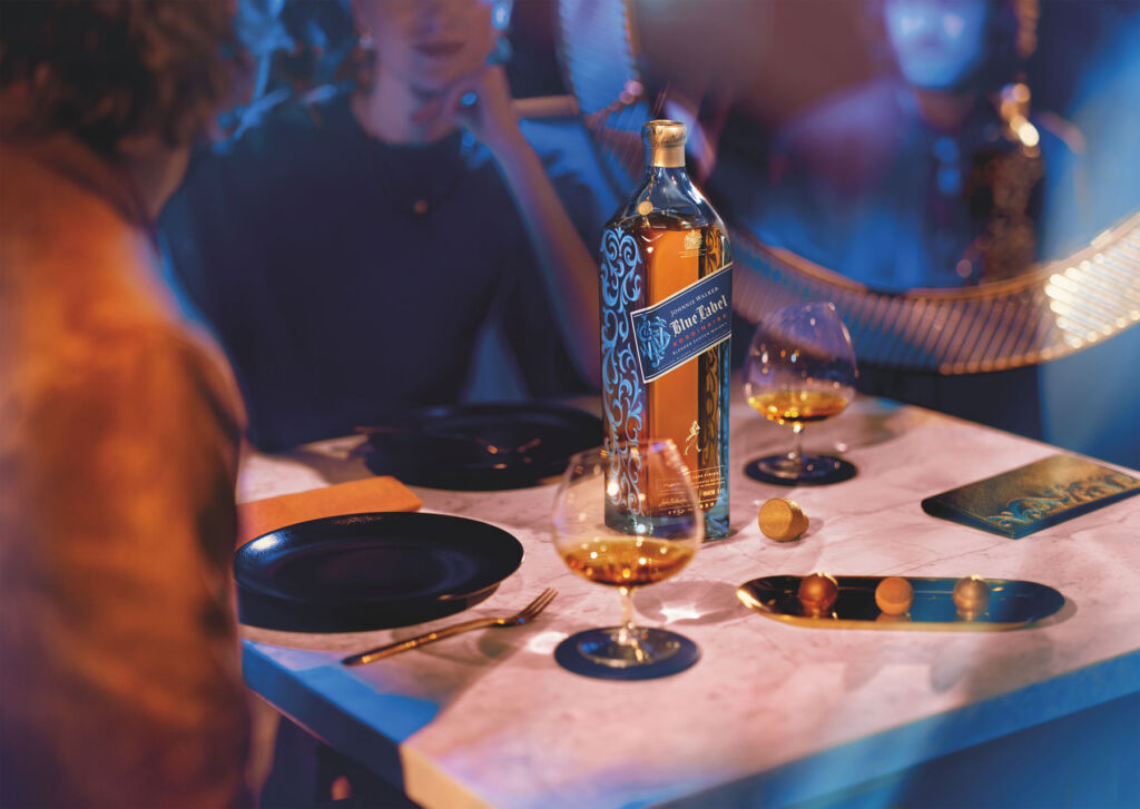 A bottle of Blue Label Xordinaire on a dining table