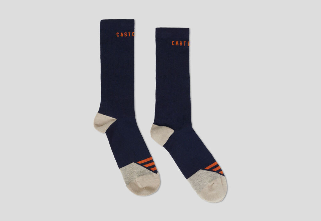 A pair of the hiking socks in a dark blue and cream colour with orange stripes