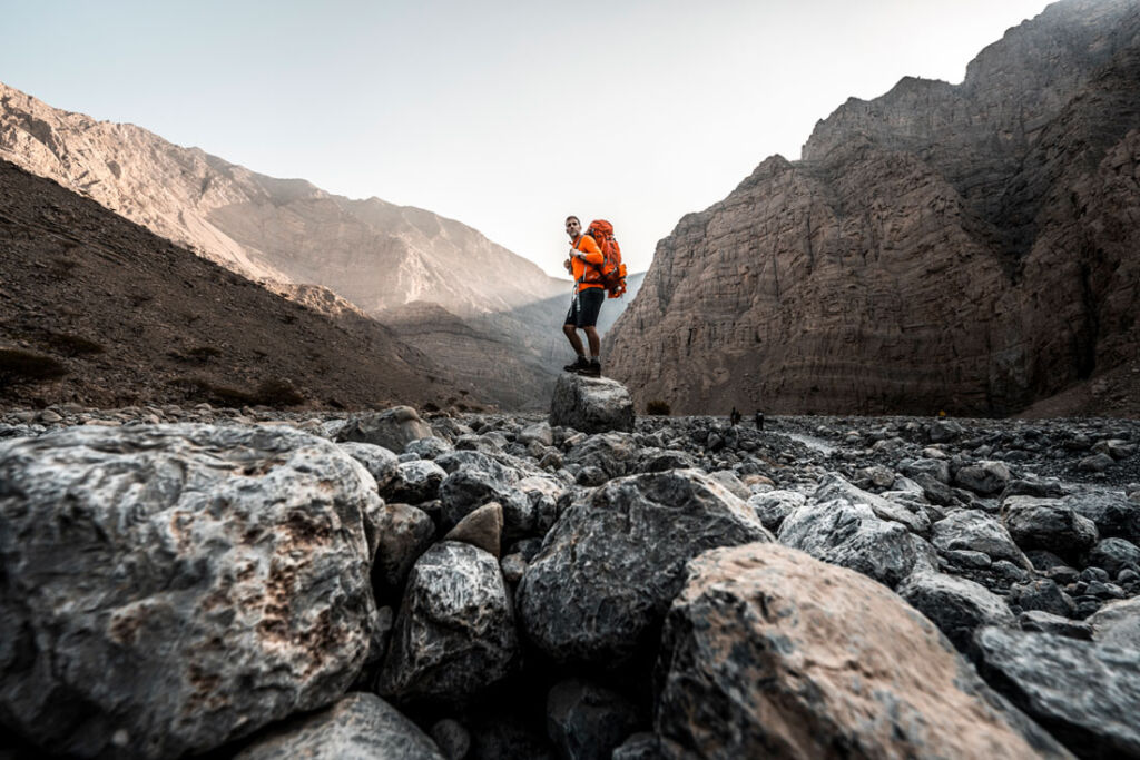 A hiker walking through a rocky valley