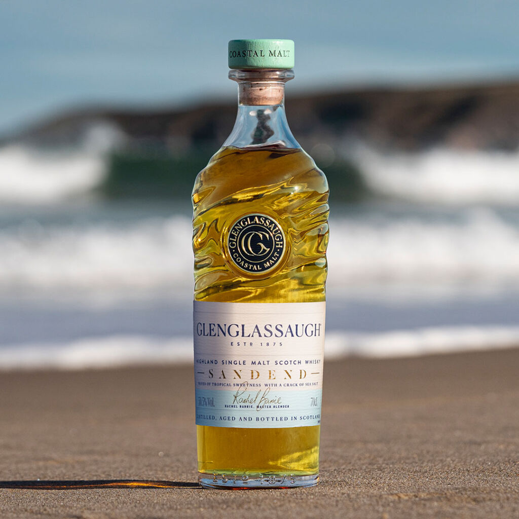 A bottle of the whisky placed on the beach