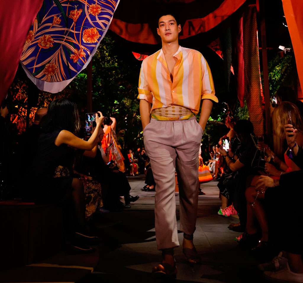 A male model walking down the catwalk