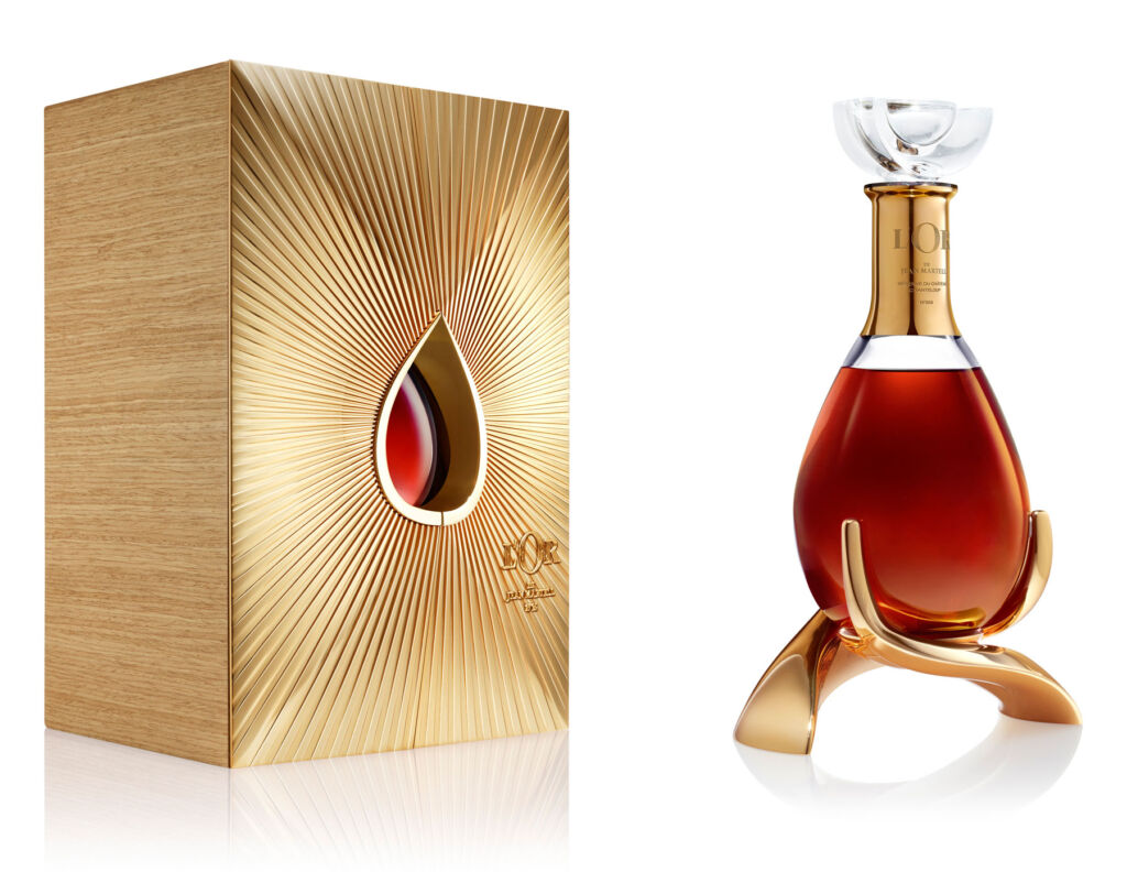 An image showing the decanter next to its gold coloured case