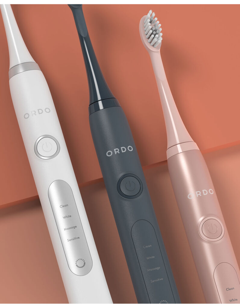 Three different coloured versions of the sonic toothbrush side-by-side