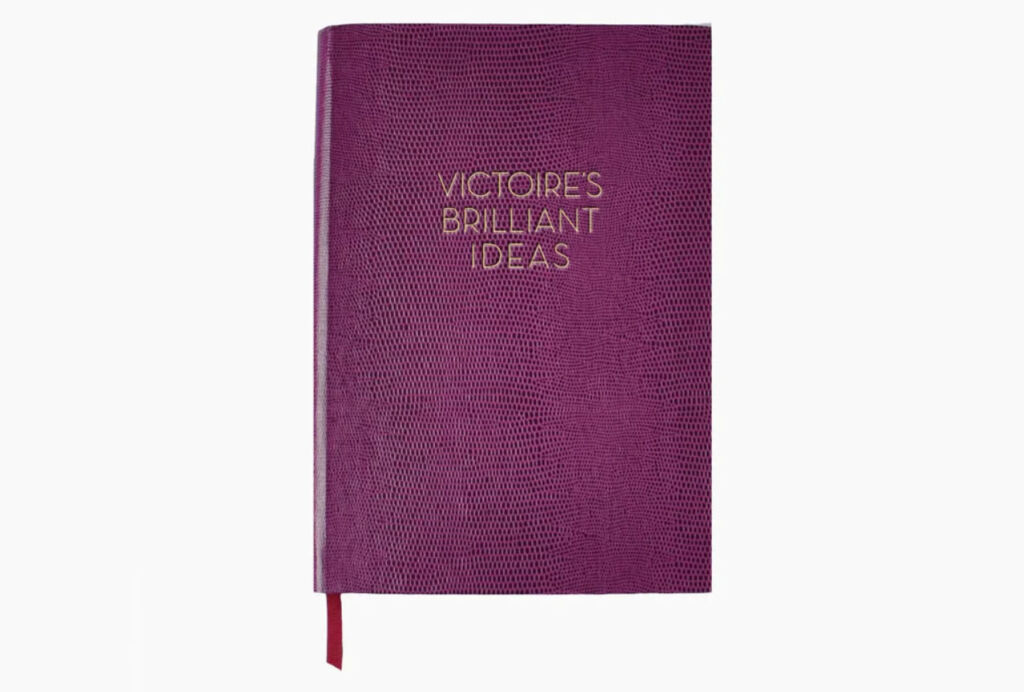 A purple coloured journal with gold words on its front cover